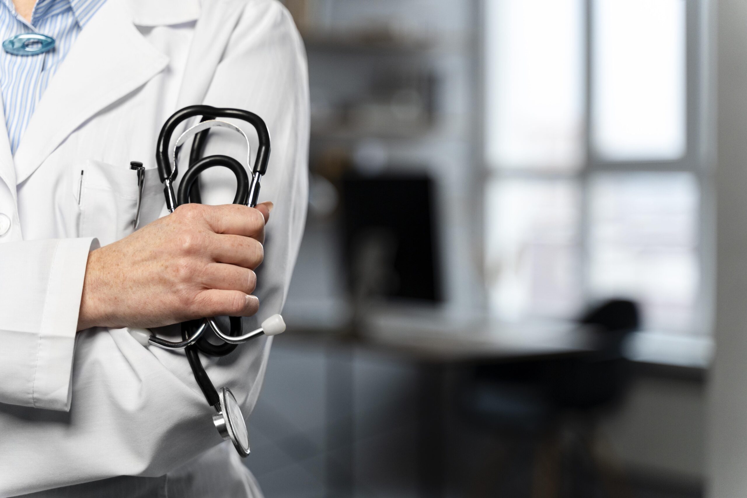front-view-female-doctor-holding-stethoscope-with-copy-space-scaled